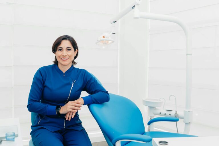 Smiling female dentist sitting in a modern clinic, ready for patients